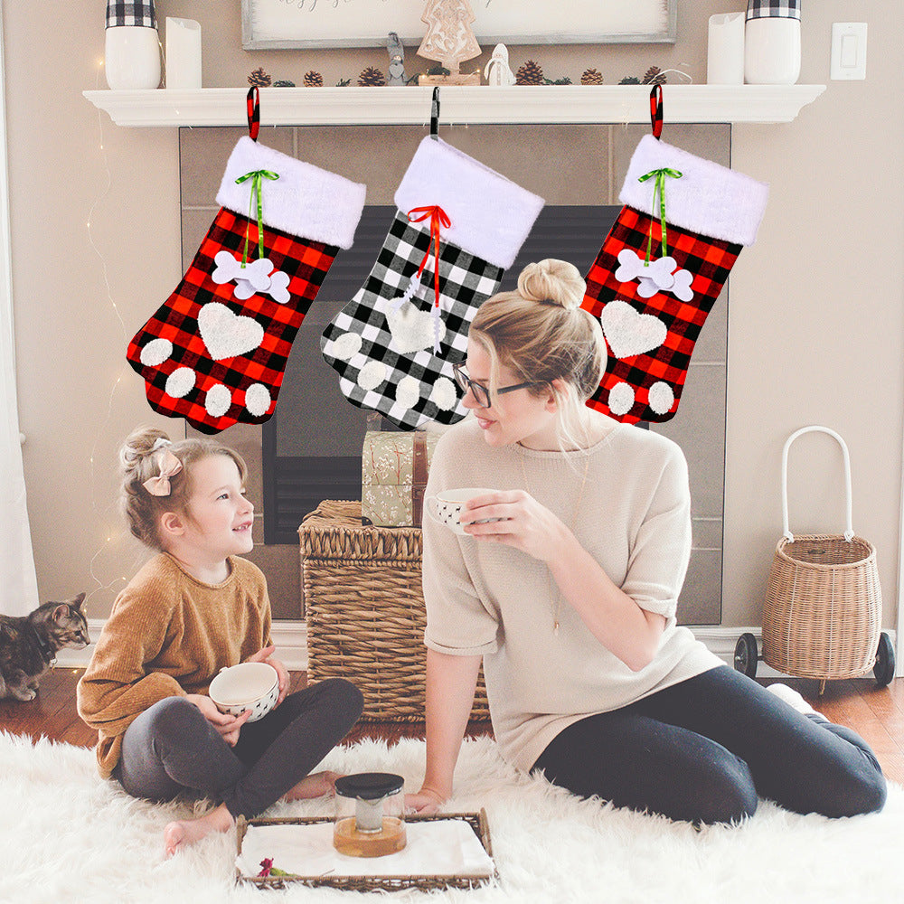 Red and black plaid Christmas socks with dog paws